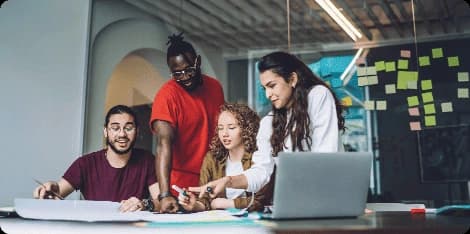 Diverse team collaborating around a table in a modern office