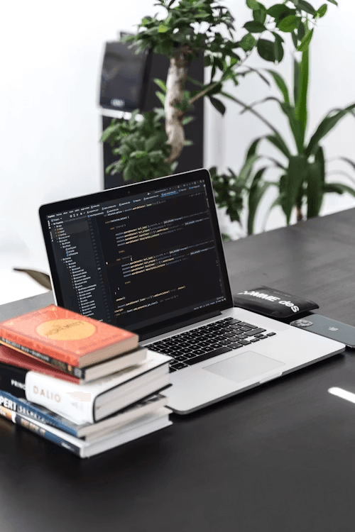 Modern workspace with laptop showing web development code